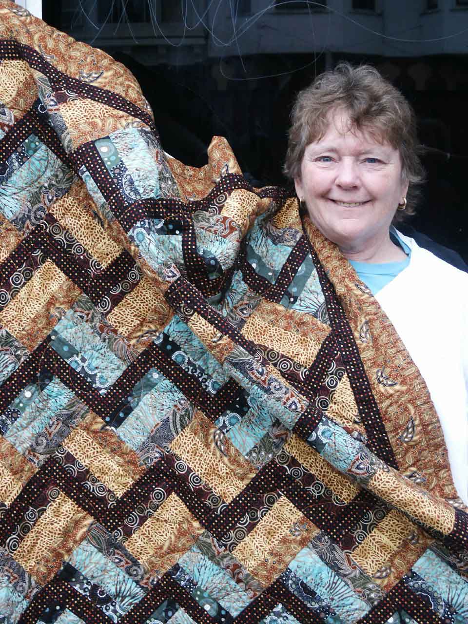 Linda Evans with her quilt for the raffle